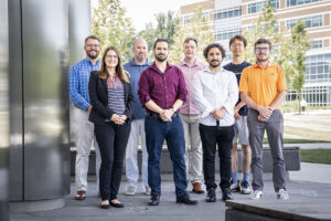 The team working on the CEREBRO project pose together outside of a facility on the APL campus. Team member names are listed in the text below the image.