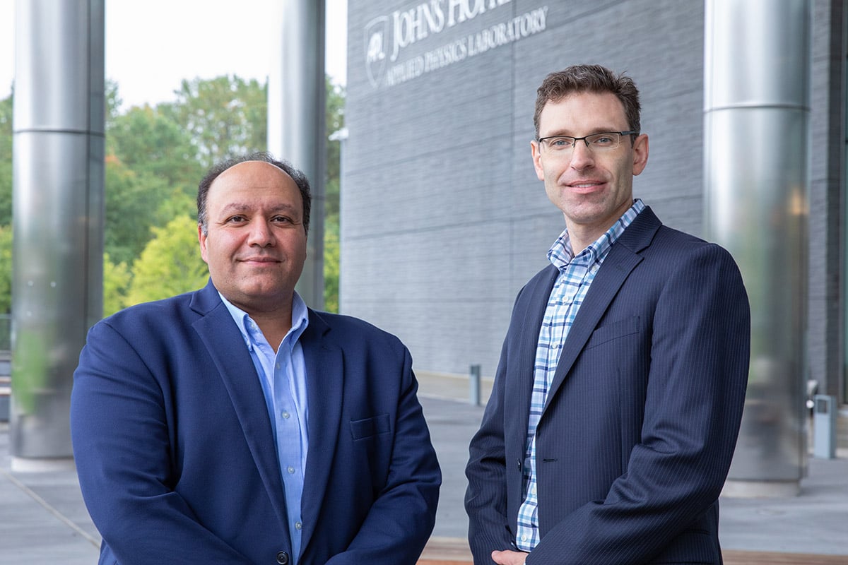 WSE PI Emad Boctor, Ph.D., and APL PI Seth Billings, Ph.D. stand beside each other on APL's campus.