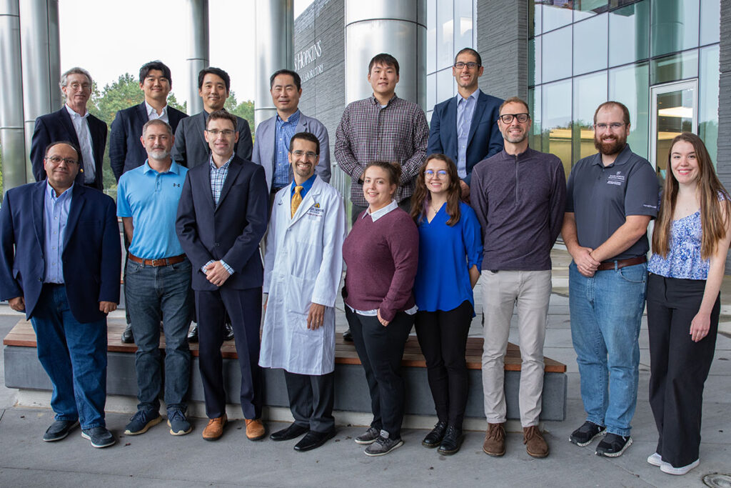 The team working on the PARS project pose together outside of a facility on the APL campus. Team member names are listed in the text below the image.